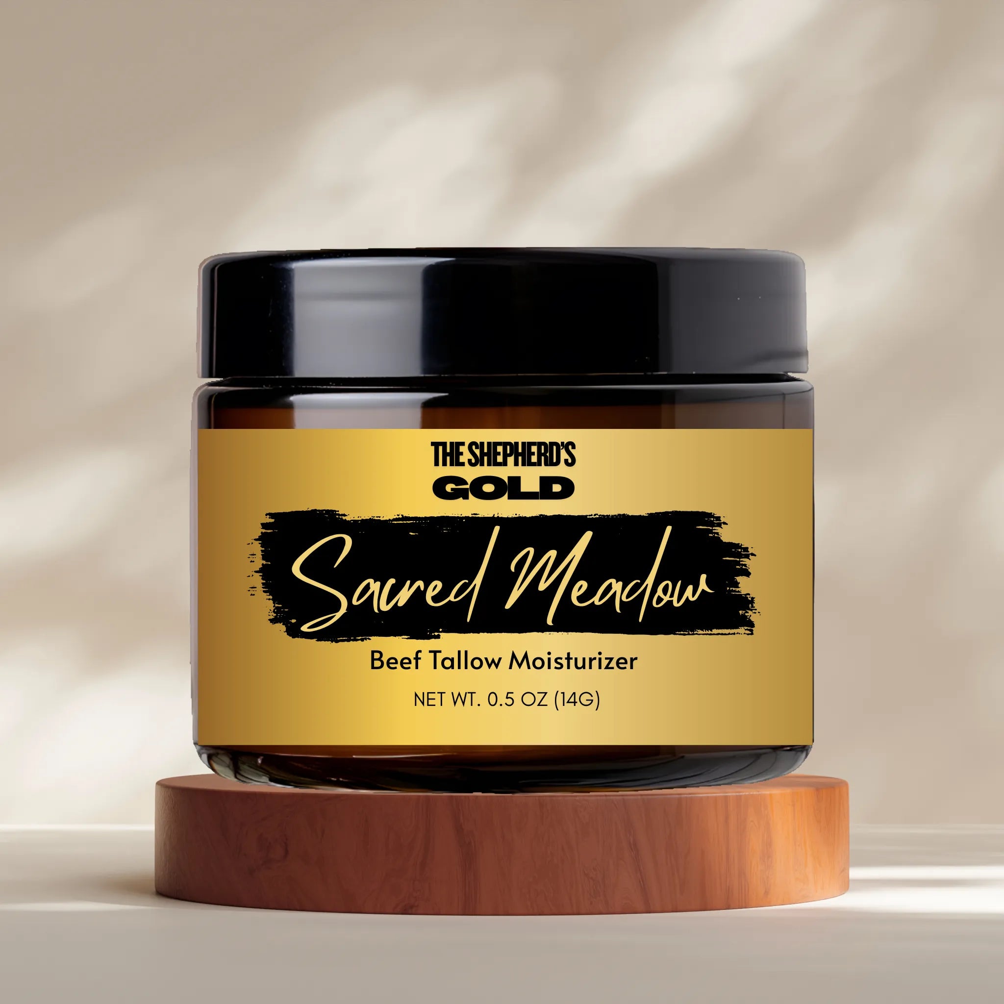Jar of 'The Shepherd's Gold Sacred Meadow' beef tallow moisturizer on a wooden stand with a neutral background.
